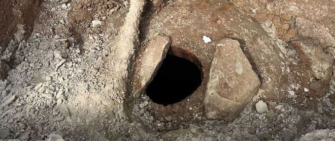 a hole in the ground leading to a cistern