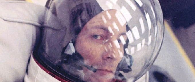 an astronaut in his space suit gazes at the camera