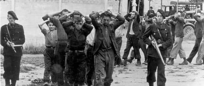 german soldiers lead captured members of the french resistance